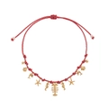 Macro detail of ocean-themed necklace with gold fishbone and seahorse charms on braided rope - Burgundy