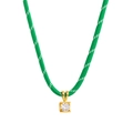 Detailed macro view of square gold-plated pendant with white zircon on green woven cord - Square Pendant / Green