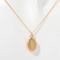 Golden necklace with oval translucent pendant featuring a yellow dandelion floral design - Daisy (DAISY)