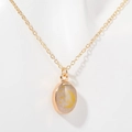 Gold moon and stars necklace with white oval gemstone pendant on a white background - Moon & Stars (MOOM&STARS)