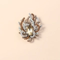 Elegant drop-shaped crystal brooch with amber rhinestones on a beige background - Champagne Ancient Silver