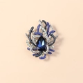 Detailed close-up of a blue pear-shaped crystal brooch with sparkling rhinestones - Antique Silver Royal Blue