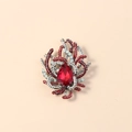 Detailed macro view of a vintage crystal brooch with a red teardrop stone and gold base - Red Antique Silver
