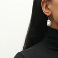 Elegant French baroque irregular pearl earrings with gold hooks worn by a model - White KC Gold (Pearl Drop)
