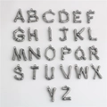 Detailed macro view of 26 bamboo-style metal letter pendants for DIY jewelry making - Letter A / L