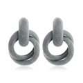 Macro shot of grey flocked interlocking rings earring with a soft velvet texture for winter - Gray
