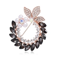 Macro shot of rose gold flower brooch with pearls, marquise gems, and crystal details - Gray Rose Gold