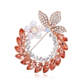 Elegant rose gold floral brooch with orange crystals and pearls on white background - Peach Rose Gold