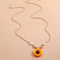 Detail view of sunflower pendant with pearls and a rose gold chain on beige background - Style 3: Rose Gold (Necklace)