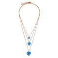 Close-up of triple-layered gold chain necklace featuring blue heart pendants and crystals - Gold Necklace (Blue Heart Pendant) / Blue