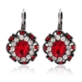 Detail of vintage silver earrings with oval red crystal and sparkling rhinestone border - Red