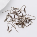 Close-up of bulk bronze fish hook ear wires with spring and bead for DIY jewelry making - Bronze Style (A498)