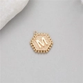 Macro detail of a 14K gold plated hexagonal M-letter pendant with beaded edges - Letter M (P24279-M)