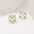 Detail view of gold clover earrings with green zircon and pavé diamonds, weighing 3.15g - 14K Gold Green Gem Star (H-11955)