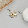 Macro view of gold bow pendant with pear-shaped cubic zirconia stones and measurements - Gold Style 6