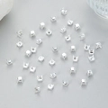 Macro view of silver square claw settings for DIY jewelry making on a grey background - Silver No Hole (SUM0003)