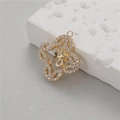 Golden flower pendant with white zircons on a textured stone display background - Hollow Flower Style (D1597)