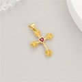 Macro shot of a 14K gold cross pendant with rose details and a red heart-shaped zircon - Gold Rose Red Gem