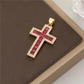 Close-up of 14K gold cross pendant with red gemstones and zircon halo on leather - Gold Red Zirconia