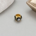 Macro shot of evil eye bead jewelry accessory with 14K gold-plated finish and enamel - Black