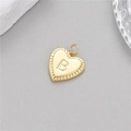 Macro shot of gold heart pendant with letter B engraving and twisted rope edge detail - Letter B (H-10513)
