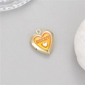 Macro detail of heart-shaped gold locket with orange enamel and SWEET engraving - Orange (H-12093)