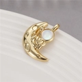 Macro shot of gold astronaut sitting on a crescent moon pendant with cat eye stone - Astronaut Sitting On Moon - White (H-8060 White)
