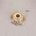 Macro shot of 9mm 14K gold plated flower bead spacer with pink zircon and hollow patterns - Hollow Scroll With Zirconia (H-8455)
