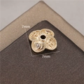 Detailed view of 14K gold-plated 7mm flower bead cap spacer with small gemstones - Four-Petal Swastika Style (H-8451)