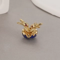 Detail of blue enamel Easter egg pendant with two golden rabbits and red zircon eyes - Dark Blue
