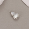 Macro view of a polished silver hulu pendant with white mother of pearl inlay - Palladium Color (H-9296)