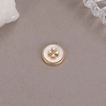 Macro detail of a gold-plated flower charm with white mother-of-pearl and zircon inlay - Mother of Pearl Clover Pendant (P20536)