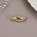 Macro view of gold jewelry magnetic clasp with white zircon stones for necklaces - Oval Ring Connector Style (14K Gold P8416)