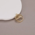 Detailed macro view of 14K gold plated sun pendant with hollow design and central zircon - Sun Pattern Hollow Round Pendant (N-0461)