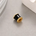 Macro shot of black enamel and gold frosted cylinder charm bead for DIY jewelry - Black