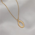 Minimalist gold oval necklace with cubic zirconia inlay on a grey silk background - Letter O (GX0028-O) / Gold