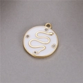 Macro detail of round gold snake pendant with white enamel and four tiny zircon stones - White