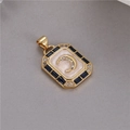 Detailed macro view of a vintage gold-plated rectangle pendant with moon and star design - Beige Enamel Moon Star Style (H-8035)