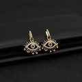 Macro shot of gold-plated evil eye earrings with white zircon pavé and star details - D740