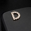 Macro detail of golden letter D pendant featuring sparkling micro-pave zircon settings - Letter D 14K Gold (H-6578)