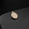 Close-up of golden oval pendant with zircon cross on black leather background - 14K Gold H-6571 (Cross Oval)