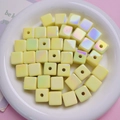 Macro shot of iridescent yellow cubic UV plated beads for DIY handmade jewelry crafting - Yellow