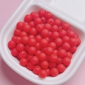 Detailed view of matte red rubberized round beads for DIY jewelry and necklaces - Red