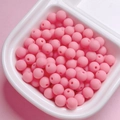 Detail shot of 6mm matte pink rubber-coated round beads for DIY jewelry making and crafts - Rose Pink