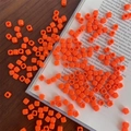 Macro detail of orange acrylic macaron square beads for DIY jewelry and phone chains - Approx. 150 Pcs (5mm, 3mm Hole) / Orange