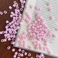 Macro shot of pink macaron square acrylic beads with center holes on a wooden desk - Approx. 150 Pcs (5mm, 3mm Hole) / Light Pink