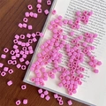 Macro detail of pink square acrylic beads with center holes on vintage book for DIY jewelry - Approx. 150 Pcs (5mm, 3mm Hole) / Rose Pink
