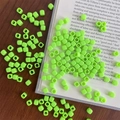 Macro shot of fluorescent green acrylic square beads with holes on a dark wooden table - Approx. 150 Pcs (5mm, 3mm Hole) / Fruit Green