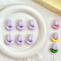 Detailed close-up of colorful tulip beads and leaf charms for DIY jewelry making - Flower / Purple