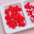 Macro shot of glossy red T-shaped and cross acrylic beads in a white jewelry display tray - 12mm (2.6mm Hole) / Red